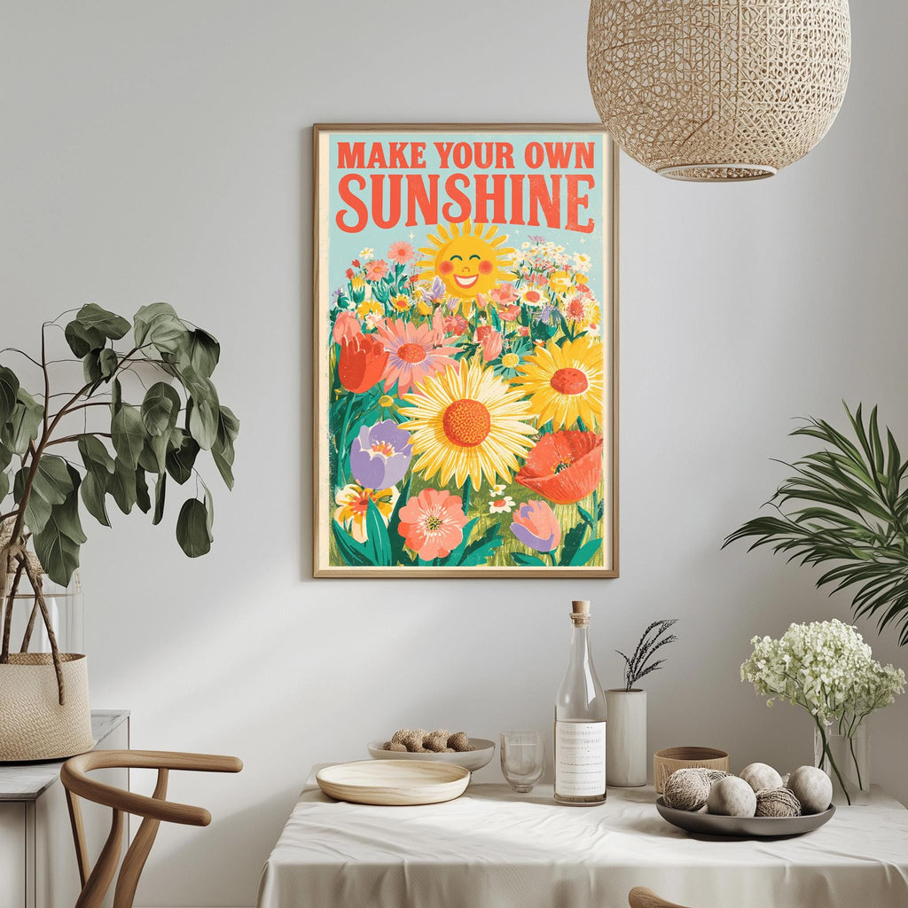 a framed poster with a vibrant illustration of a sunflower surrounded by various flowers, hanging on a wall above a dining table with a white tablecloth.