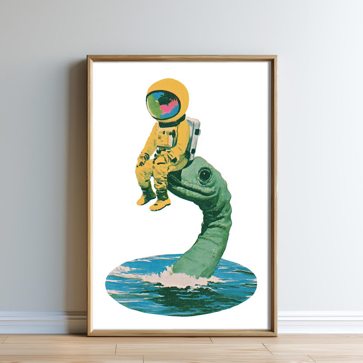 A framed illustration depicting an astronaut in a yellow suit sitting on a green sea turtle.