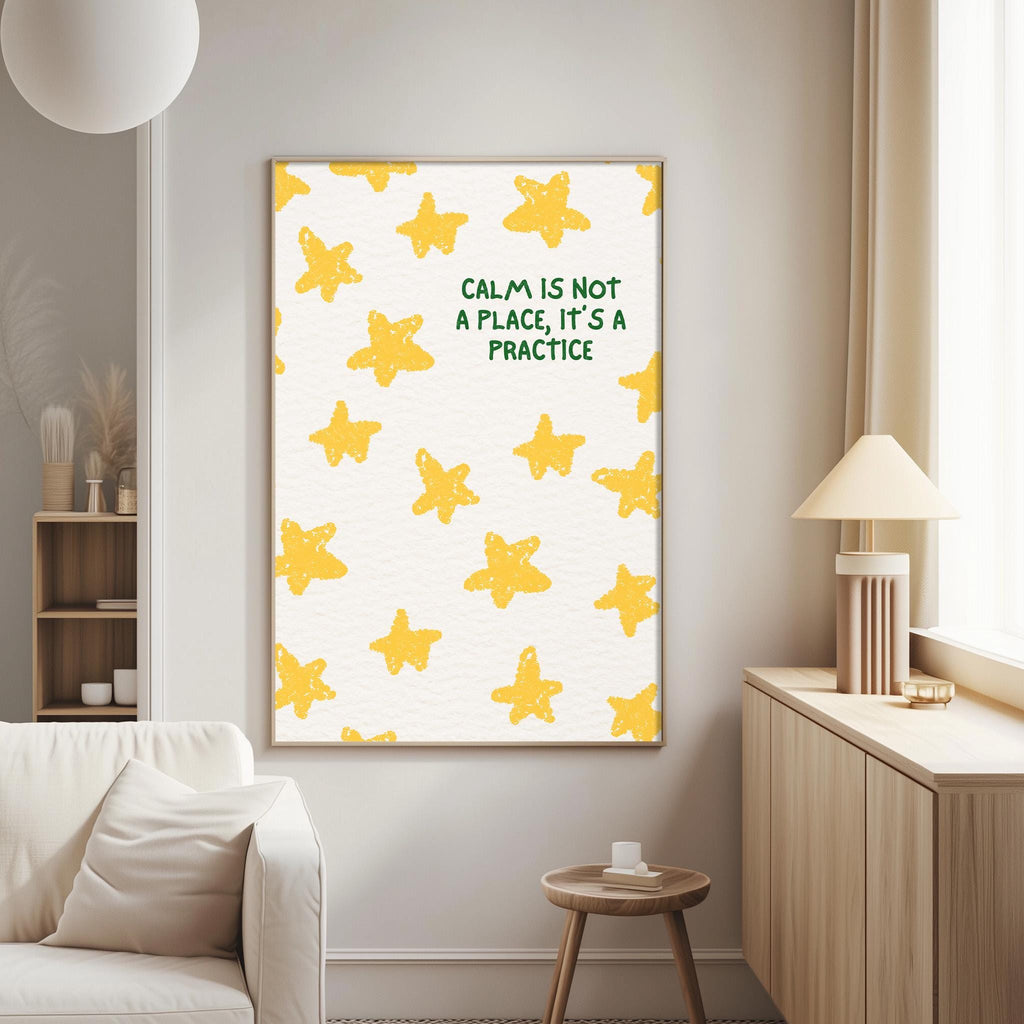 a living room with a white couch, a wooden side table, and a framed poster with a yellow star pattern on the wall.