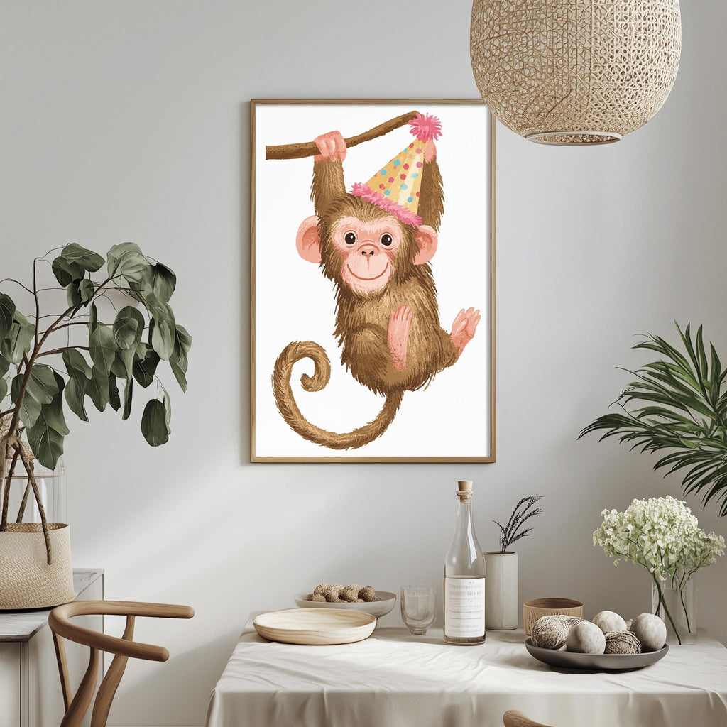 a framed illustration of a monkey wearing a party hat, hanging from a branch, and holding a stick. The monkey is surrounded by various decorative elements, such as potted plants, vases, and a table with dishes and a bottle.