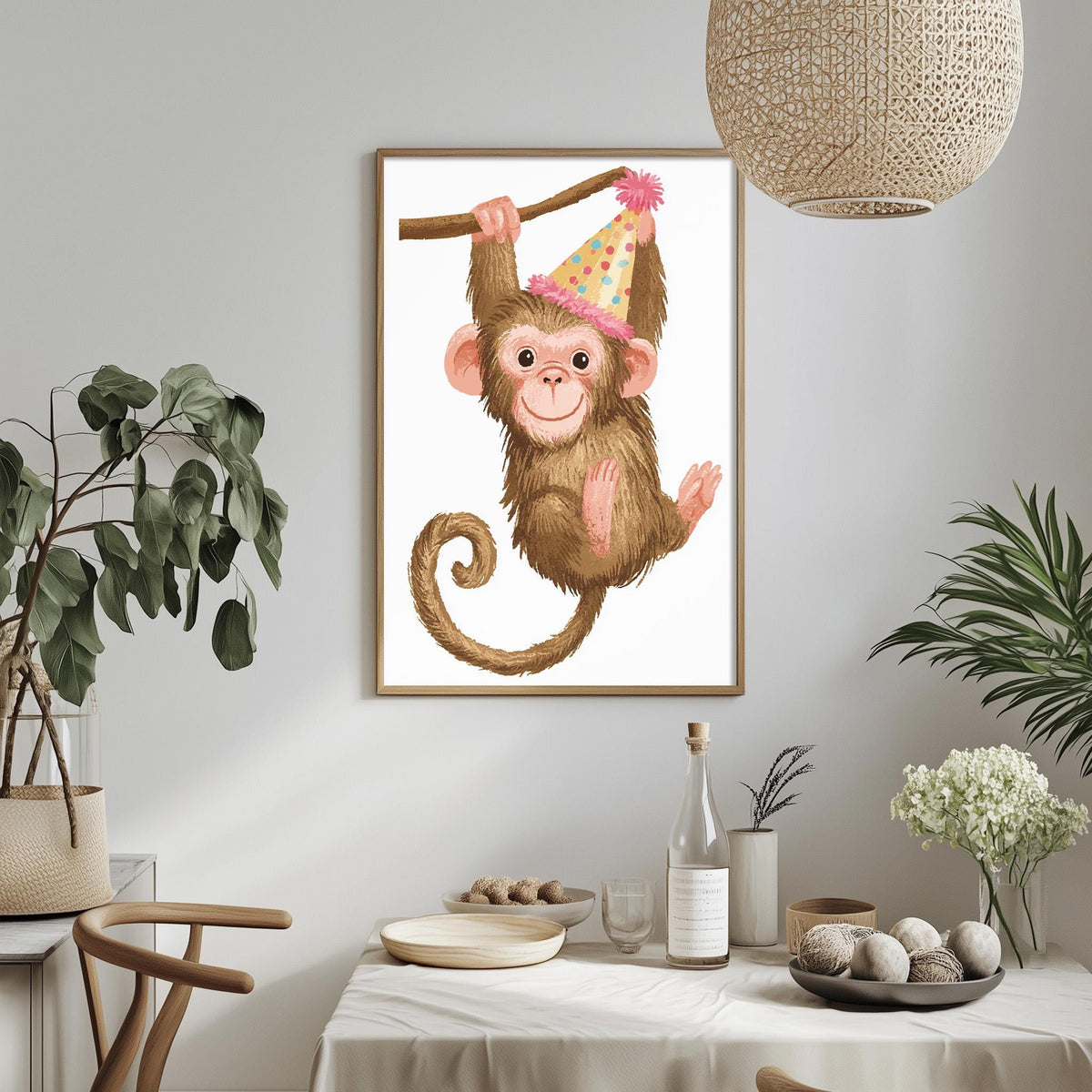 a framed illustration of a monkey wearing a party hat, hanging from a branch, and holding a stick. The monkey is surrounded by various decorative elements, such as potted plants, vases, and a table with dishes and a bottle.
