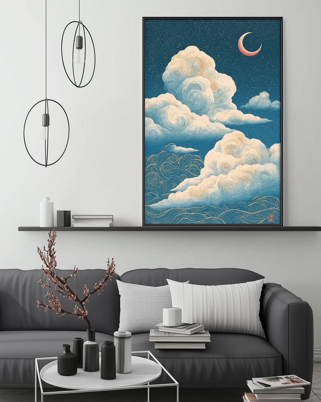 a living room with a gray sofa, a coffee table, and a large framed artwork depicting a night sky with clouds and a crescent moon.