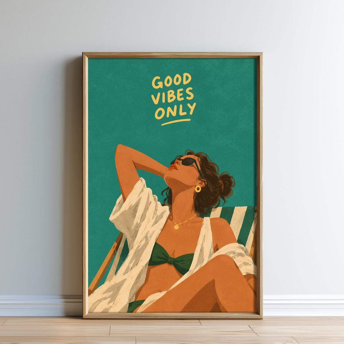 The image is a framed poster featuring an illustration of a woman in a bikini, with the text "GOOD VIBES ONLY" written above her.