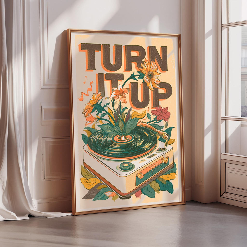 a framed poster with a vibrant illustration of a turntable surrounded by flowers and leaves, along with the text "TURN IT UP" prominently displayed.