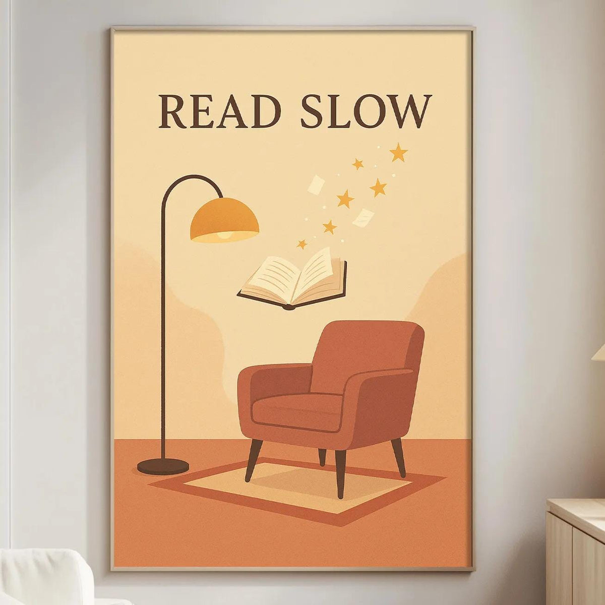 a cozy living room with a large poster on the wall that reads "READ SLOW" and includes an illustration of a red armchair, a lamp, and a book.