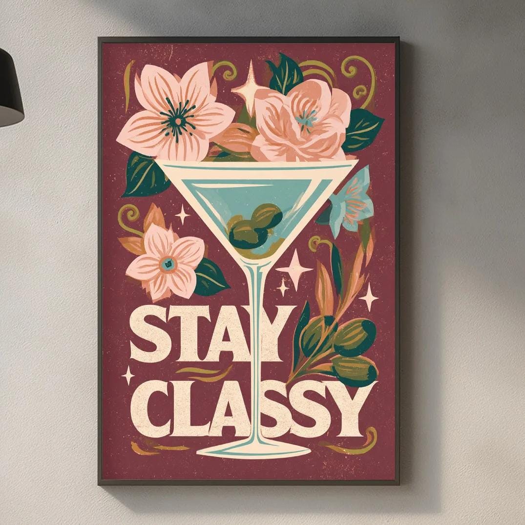 a framed poster with a vibrant design hanging on a wall above a kitchen counter.