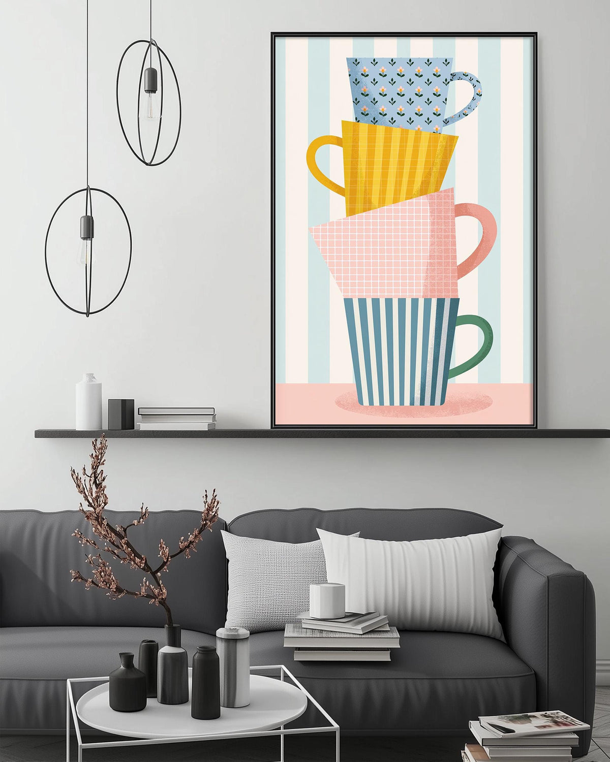a modern living room with a gray sofa, a coffee table, and a large framed artwork depicting colorful coffee cups stacked on top of each other.
