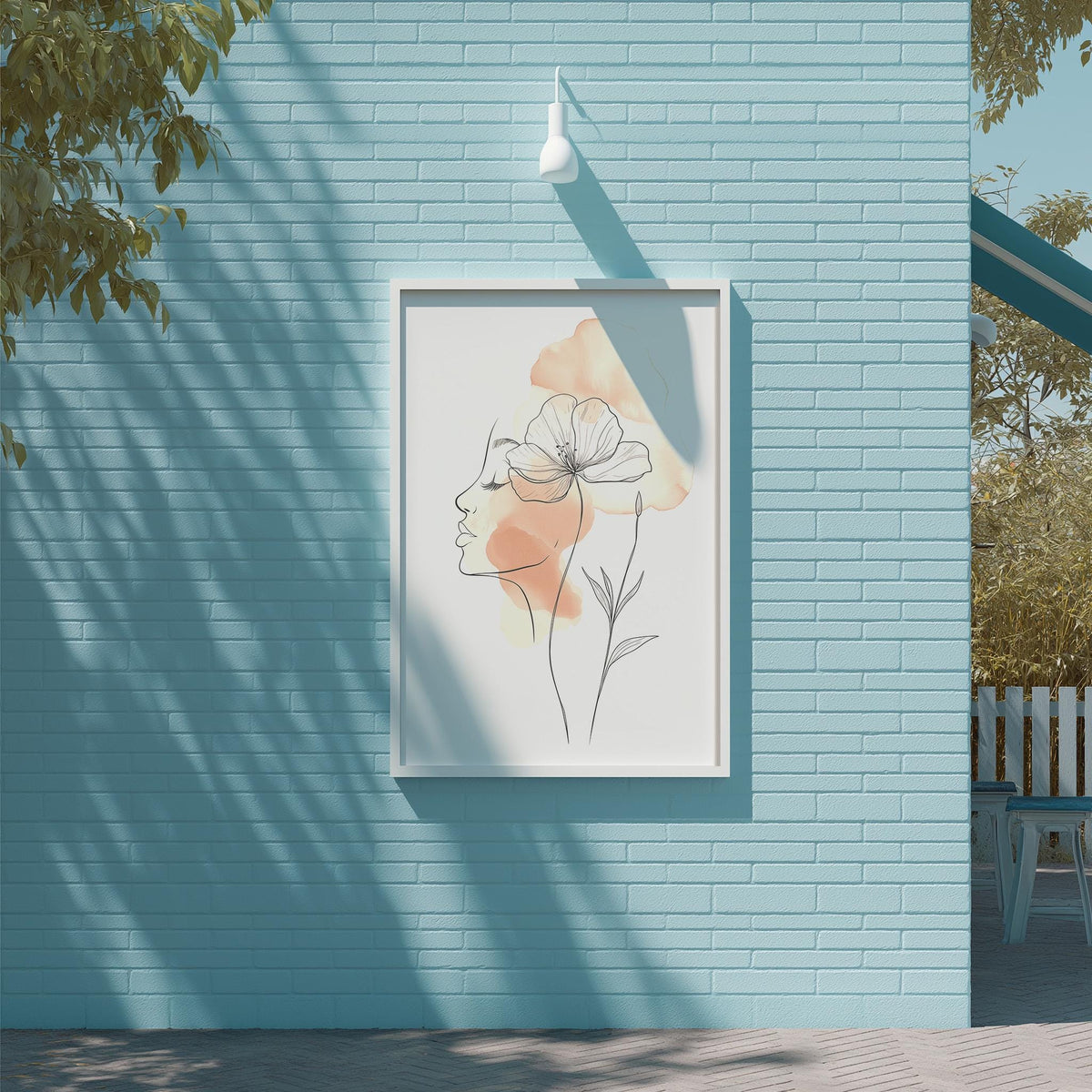 a framed artwork of a woman's face with a flower on a light blue brick wall.