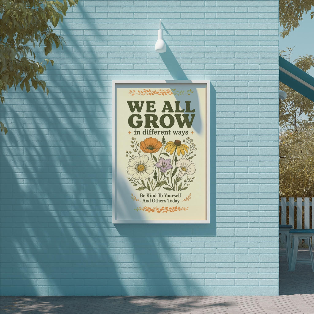 a poster with a floral design and the text "WE ALL GROW in different ways" displayed on a blue brick wall.