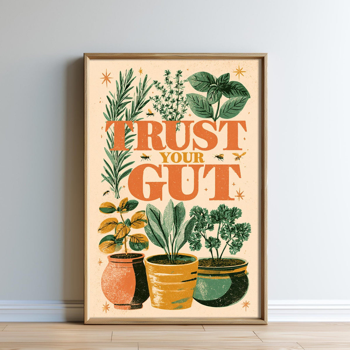 The image is a framed poster with a vibrant design featuring various potted plants and the text "TRUST YOUR GUT".