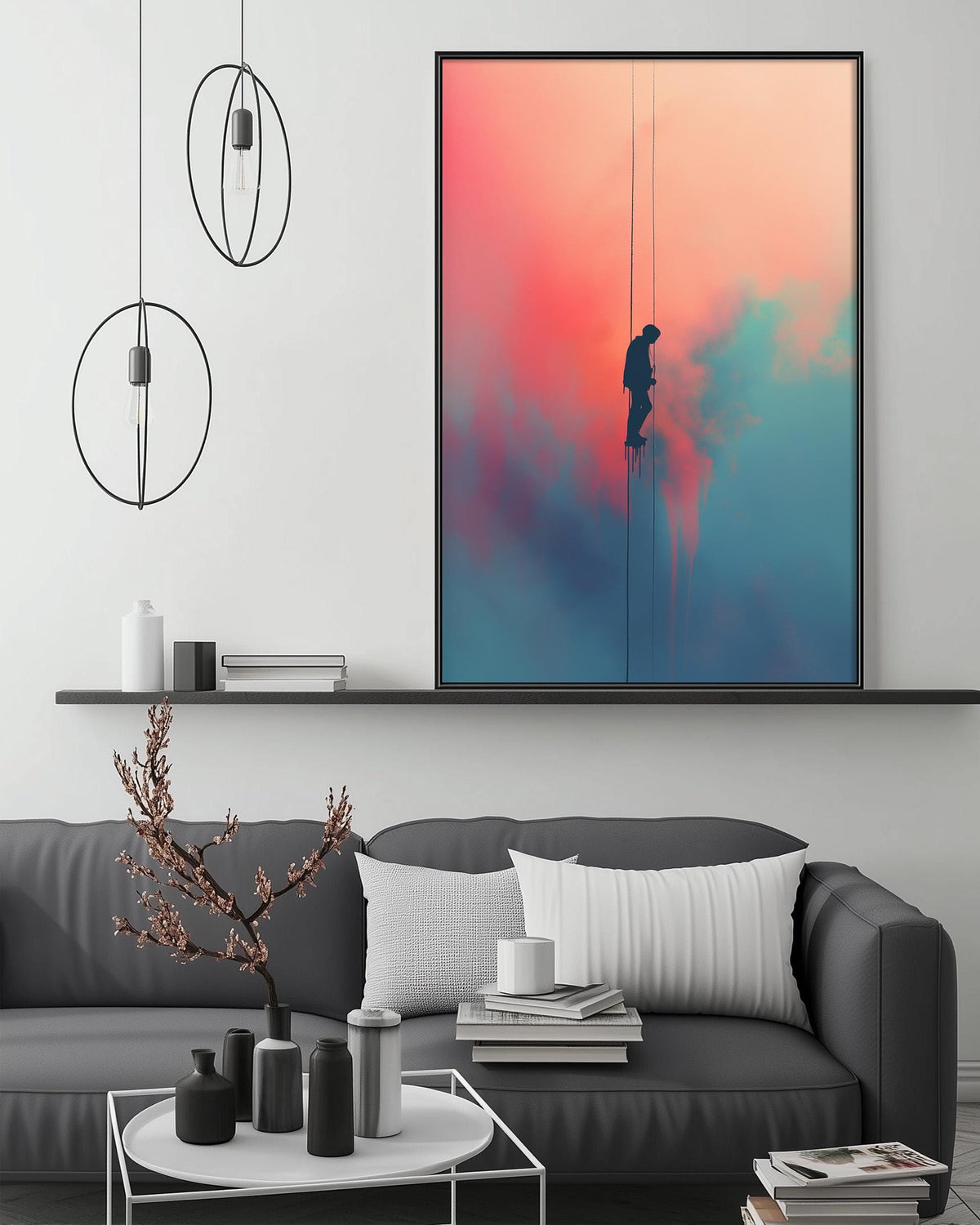 a modern living room with a gray sofa, a coffee table, and a large framed artwork depicting a person climbing a rope against a colorful sky.