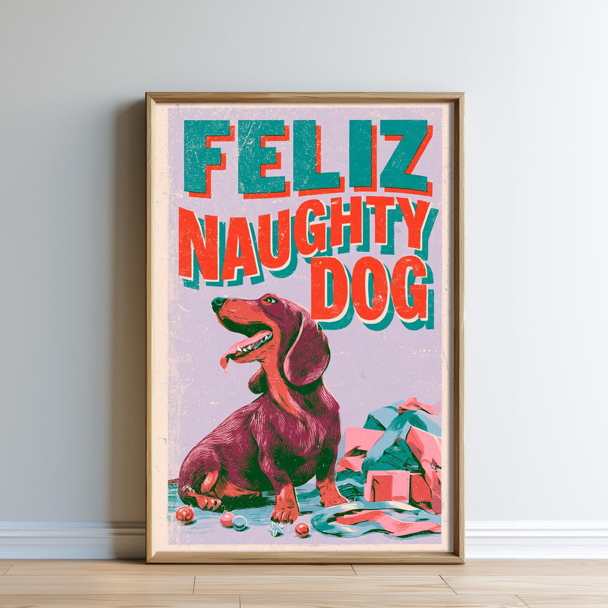 The image is a framed poster featuring a large dachshund dog sitting on the floor, with a pile of presents in front of it. The text on the poster reads "Feliz Naughty Dog".