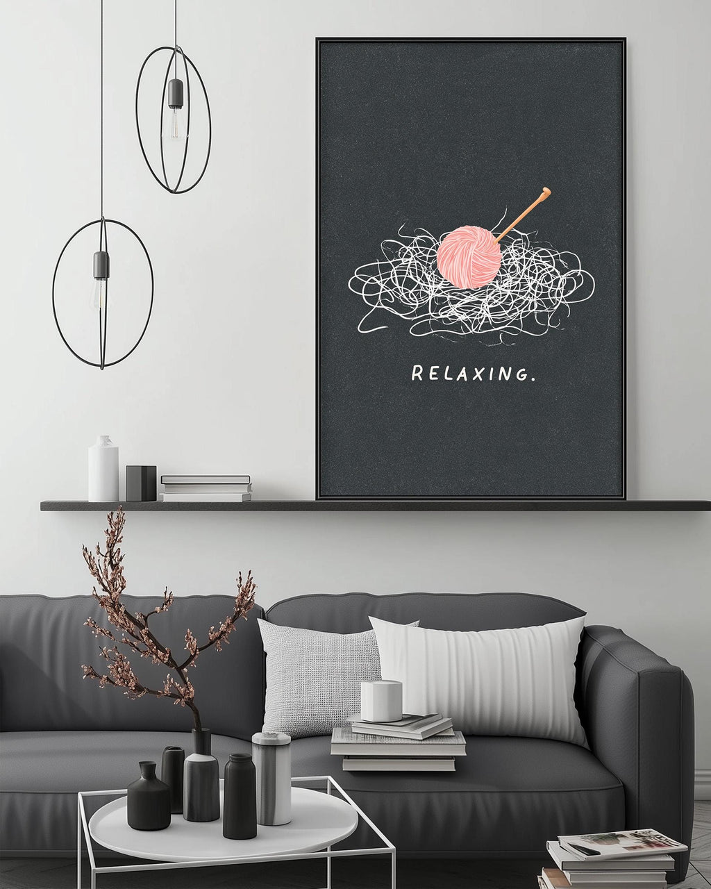 a cozy living room with a gray couch, a coffee table, and a framed poster on the wall that says "Relaxing."