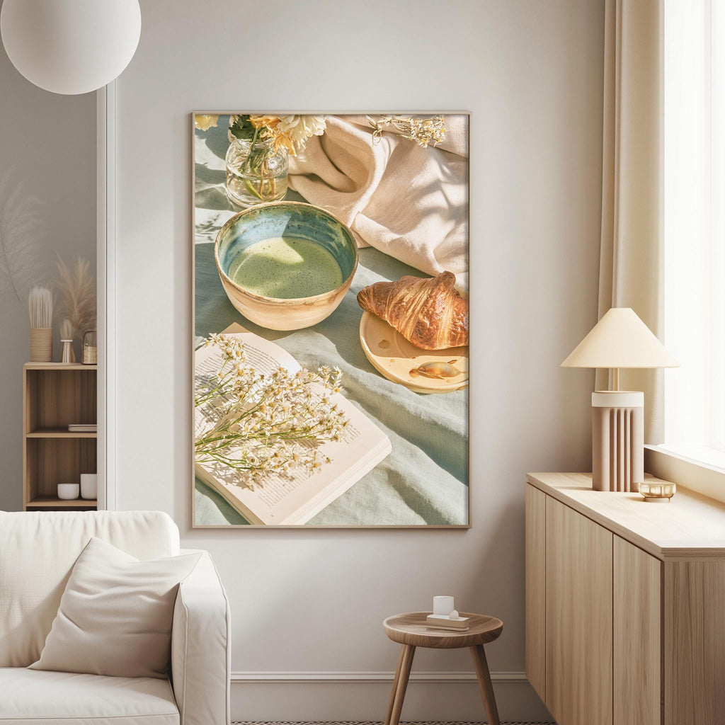 a cozy living room with a white sofa, a wooden side table, and a framed picture of a breakfast spread on the wall.