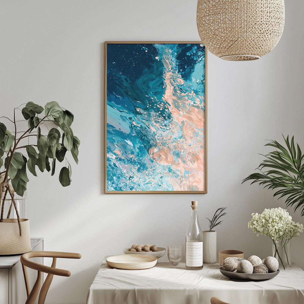 a dining table with a white tablecloth, a bowl of fruit, a bottle, and a vase with flowers. Above the table, there is a framed painting of a blue and orange abstract design hanging on the wall.
