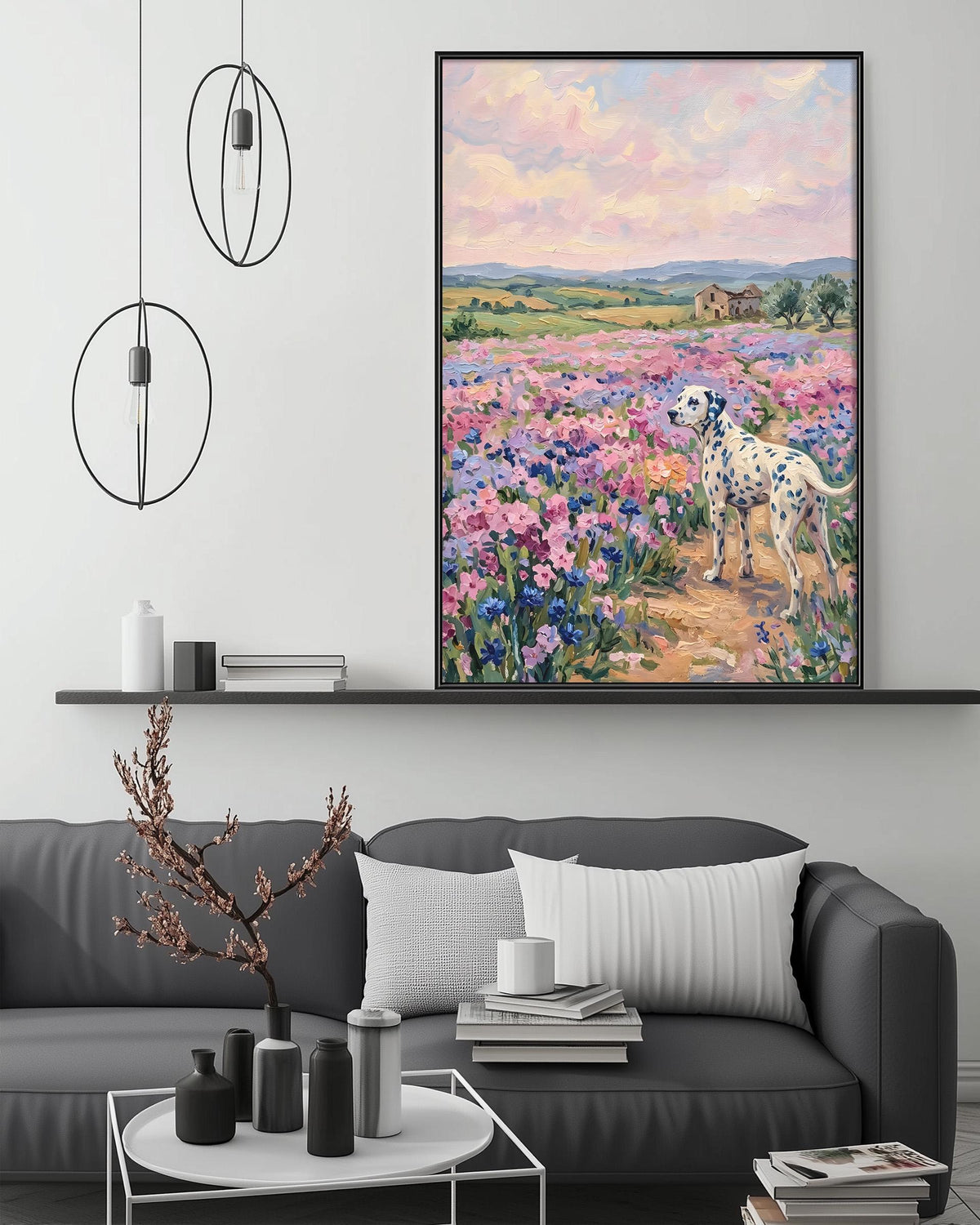 a large painting of a Dalmatian dog standing in a field of colorful flowers, with a serene landscape in the background. The painting is hung on a wall above a gray couch, which has a coffee table in front of it. The room also includes a shelf with decorative items and a potted plant.