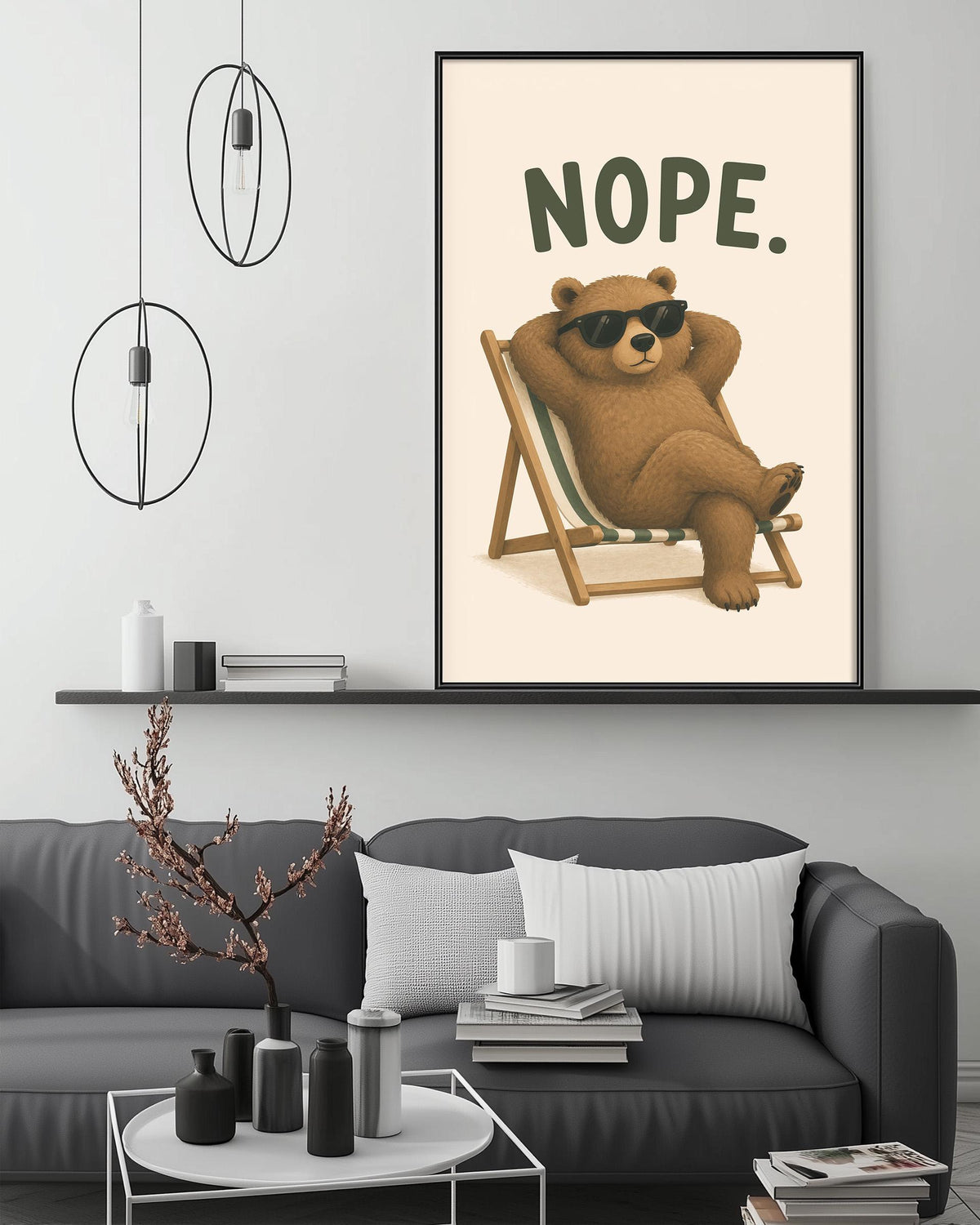 a cozy living room with a gray couch, a coffee table, and a framed poster of a bear lounging in a chair with the word "NOPE" written on it.