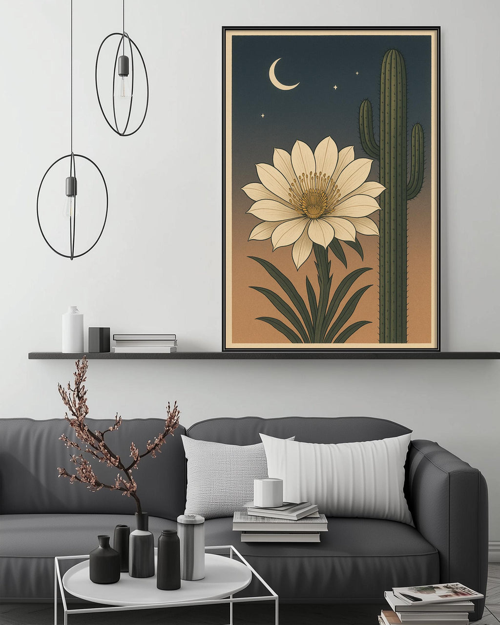 a living room with a gray sofa, a coffee table, and a large framed print of a cactus and a flower on the wall.