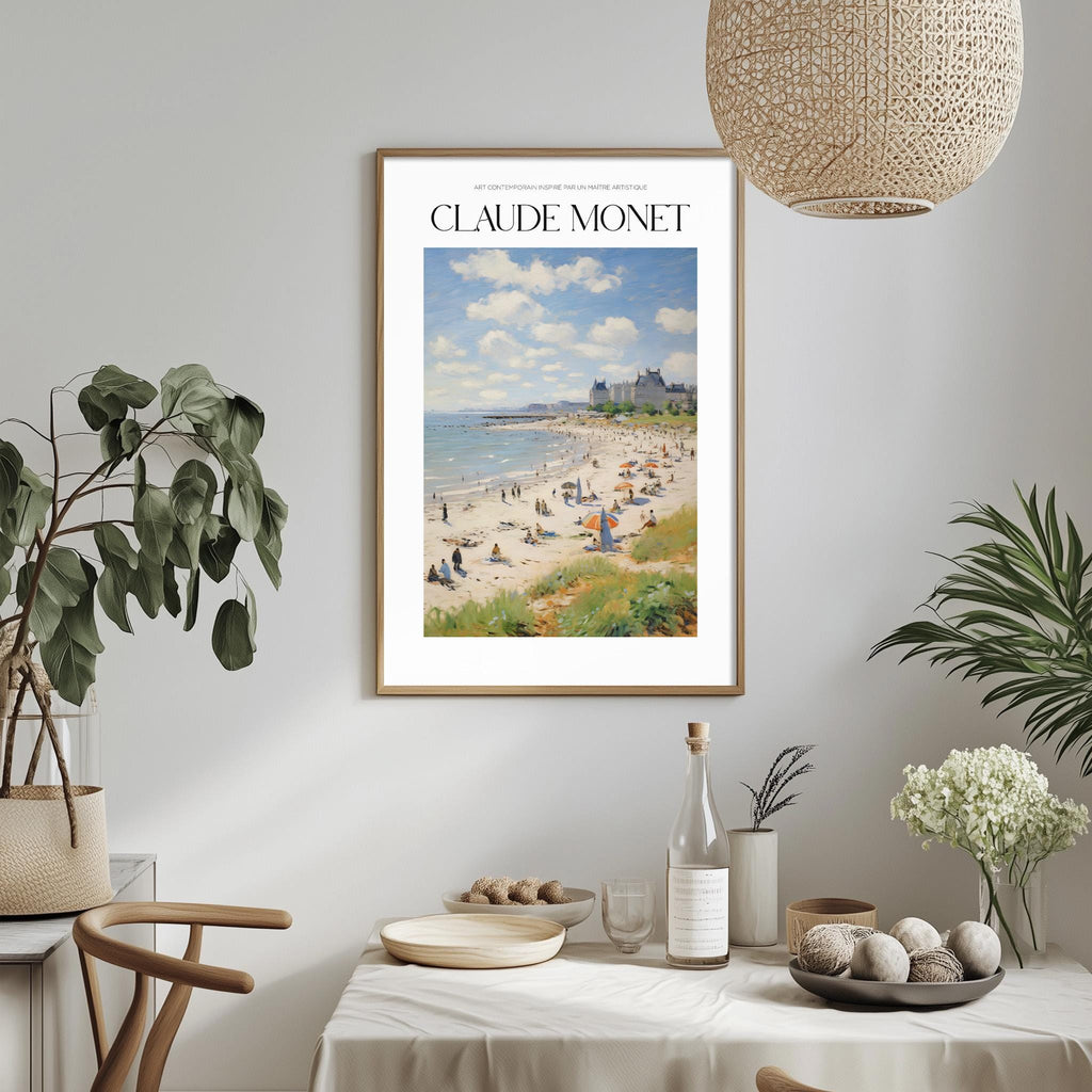 a framed painting of a beach scene with people and buildings in the background, hanging on a wall above a dining table with various items on it.