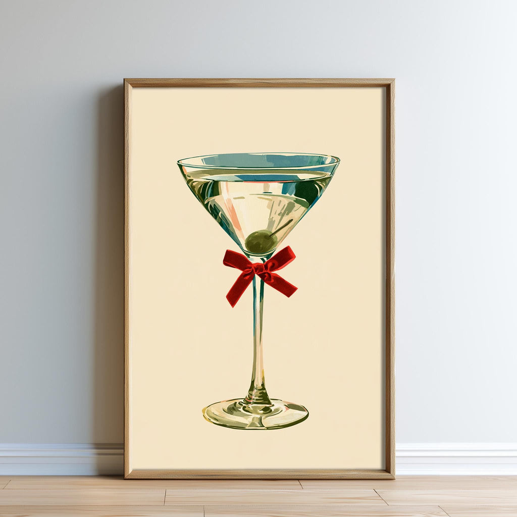 A framed illustration of a martini glass with a red ribbon.