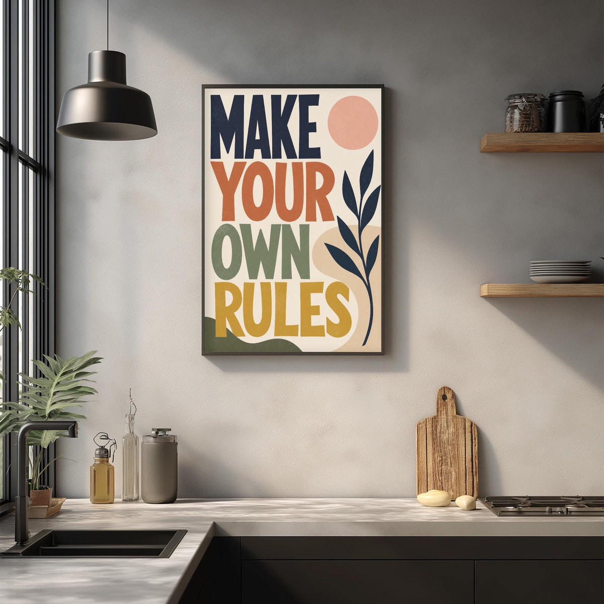 a kitchen counter with a framed poster that reads "MAKE YOUR OWN RULES" above it. The counter also has various kitchen items such as a cutting board, a knife, and a bottle.