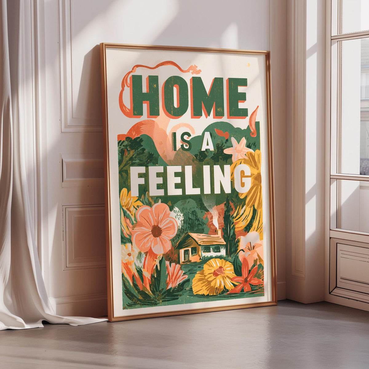 a framed poster with the text "HOME IS A FEELING" and an illustration of a house surrounded by flowers and plants.