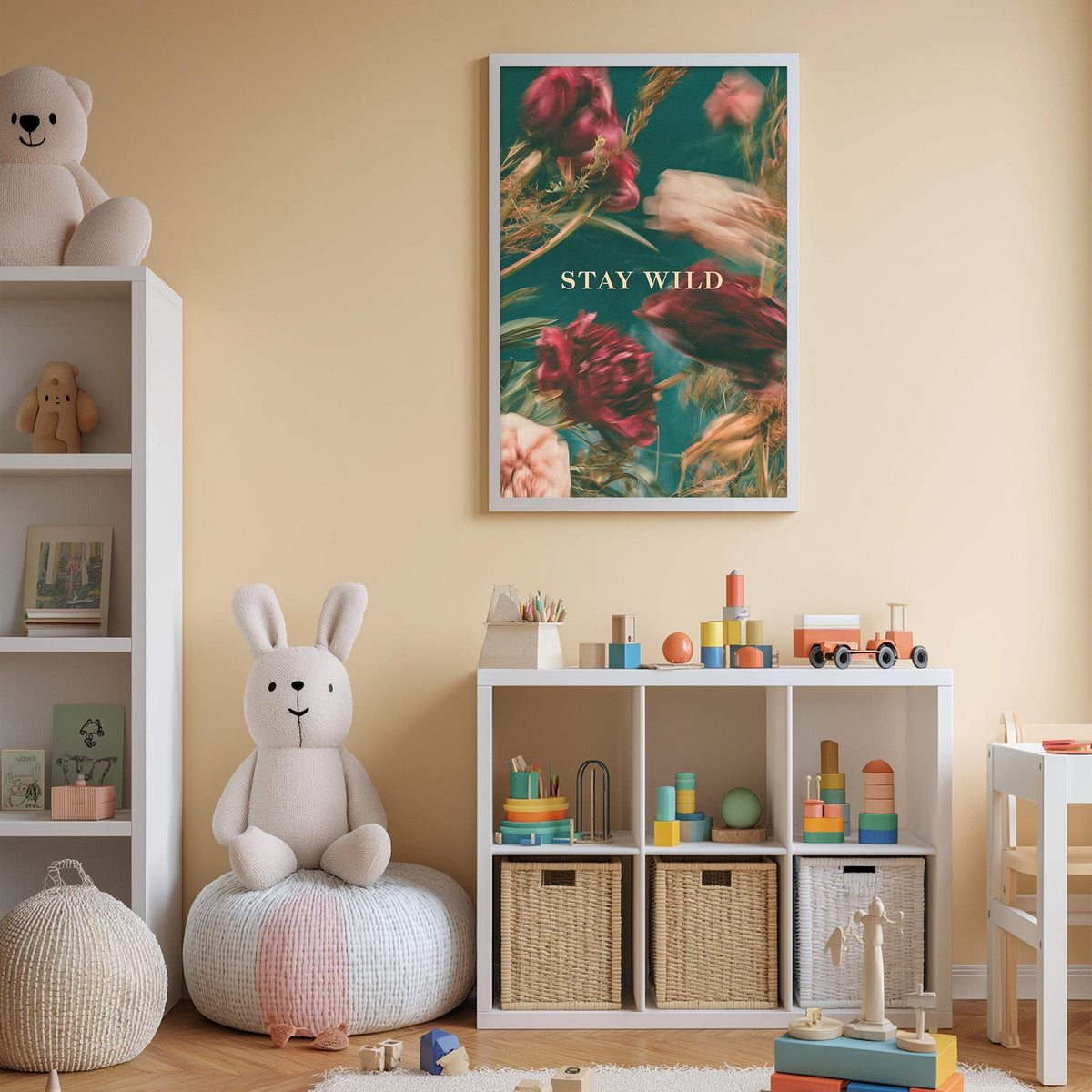 A cozy and colorful children's bedroom with a large stuffed rabbit, a bookshelf, and a toy chest filled with toys. The walls are painted a light peach color, and a framed poster with the text "STAY WILD" is displayed above the bookshelf.