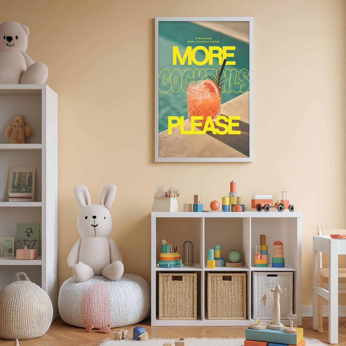 A child's bedroom with a white bookshelf, a stuffed rabbit, and a colorful poster on the wall. The poster features a cocktail glass and the text "MORE COCKTAILS PLEASE".