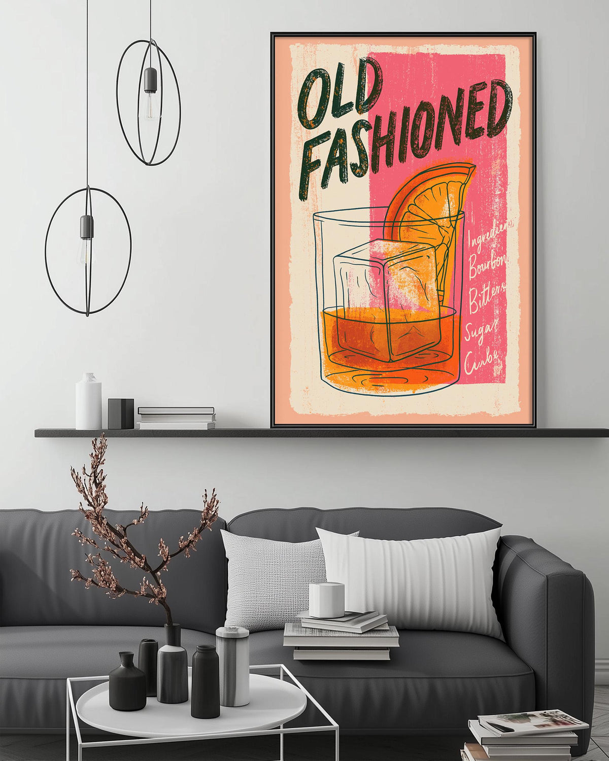 a framed poster of an illustration of a cocktail glass with an orange slice, hanging on a wall above a gray couch in a living room setting.