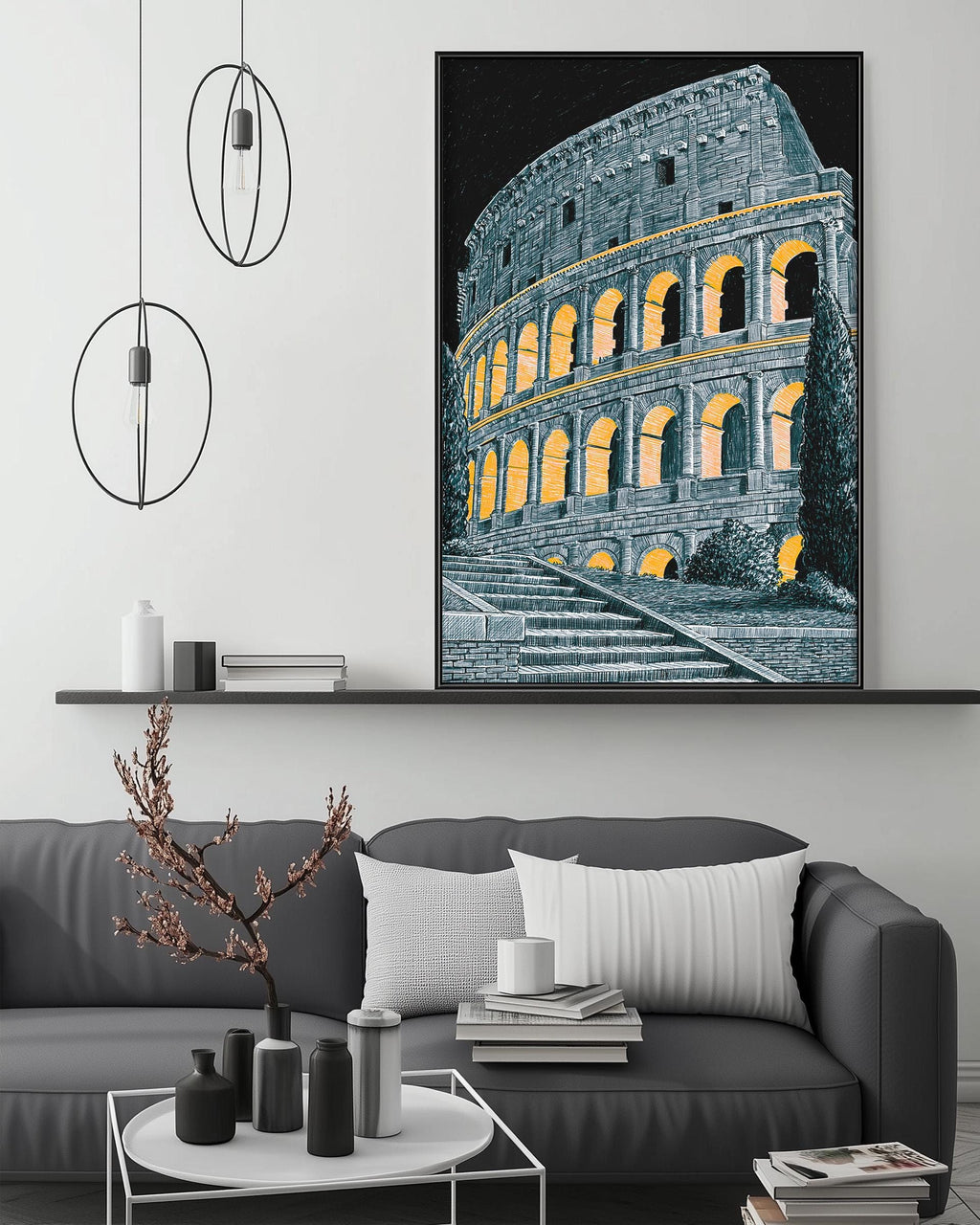 a large framed picture of the Colosseum in Rome, Italy, hanging on a wall above a gray couch with white pillows.