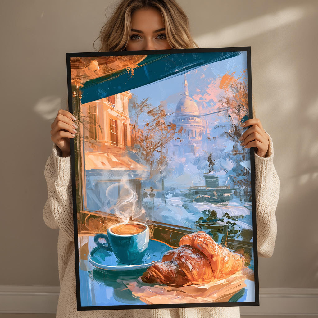 A woman holds up a framed painting depicting a cozy scene of a cup of coffee and a croissant, with a cityscape visible through a window in the background.