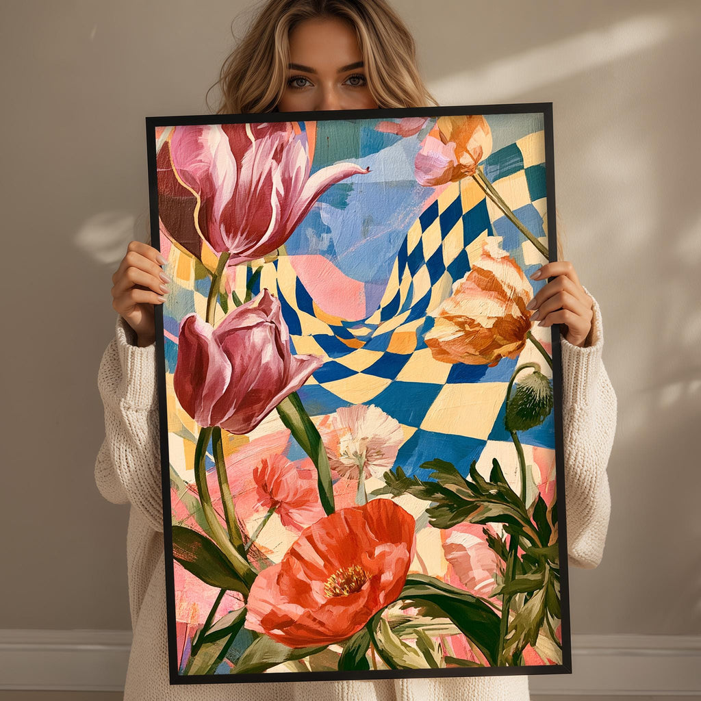 A woman holds up a framed painting of a vibrant floral arrangement, featuring a variety of colorful flowers including tulips, poppies, and other blooms.