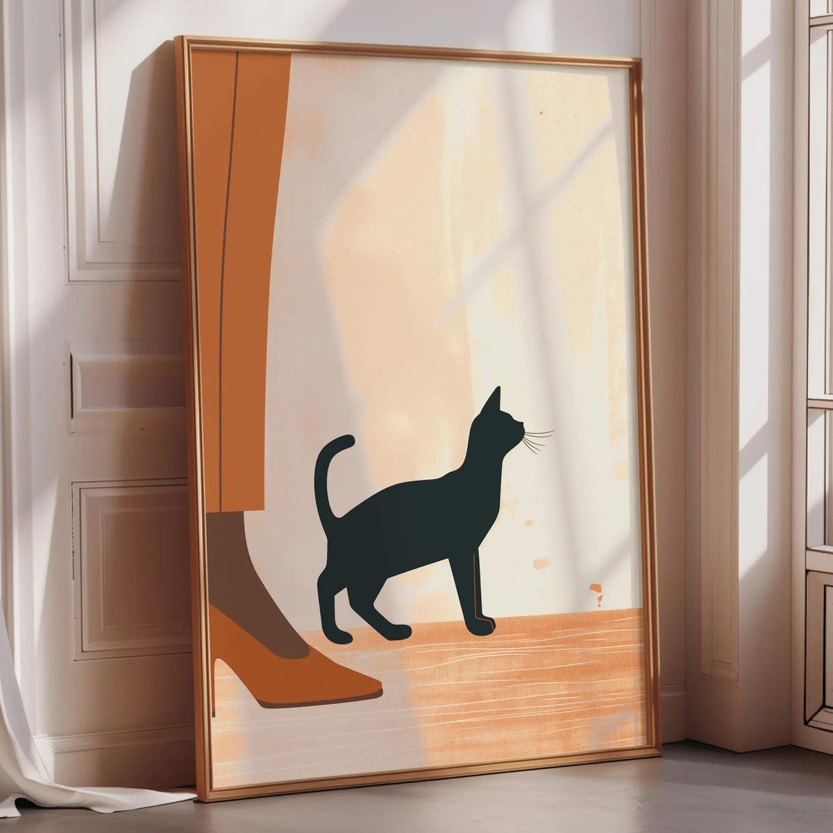 A framed illustration of a black cat standing on a wooden floor, with a person's leg visible in the background.