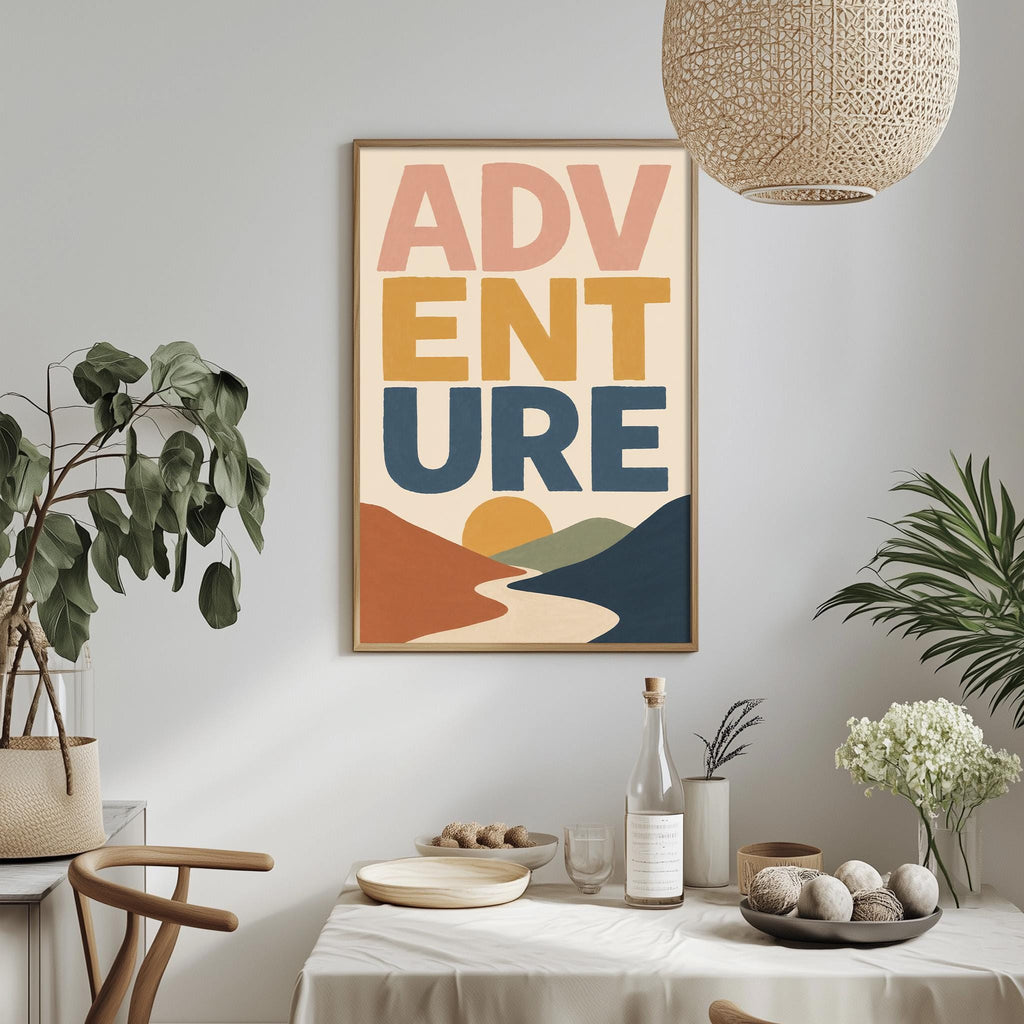 a dining table with a bowl of fruit, a bottle, and a vase of flowers, along with a framed poster hanging on the wall above the table.