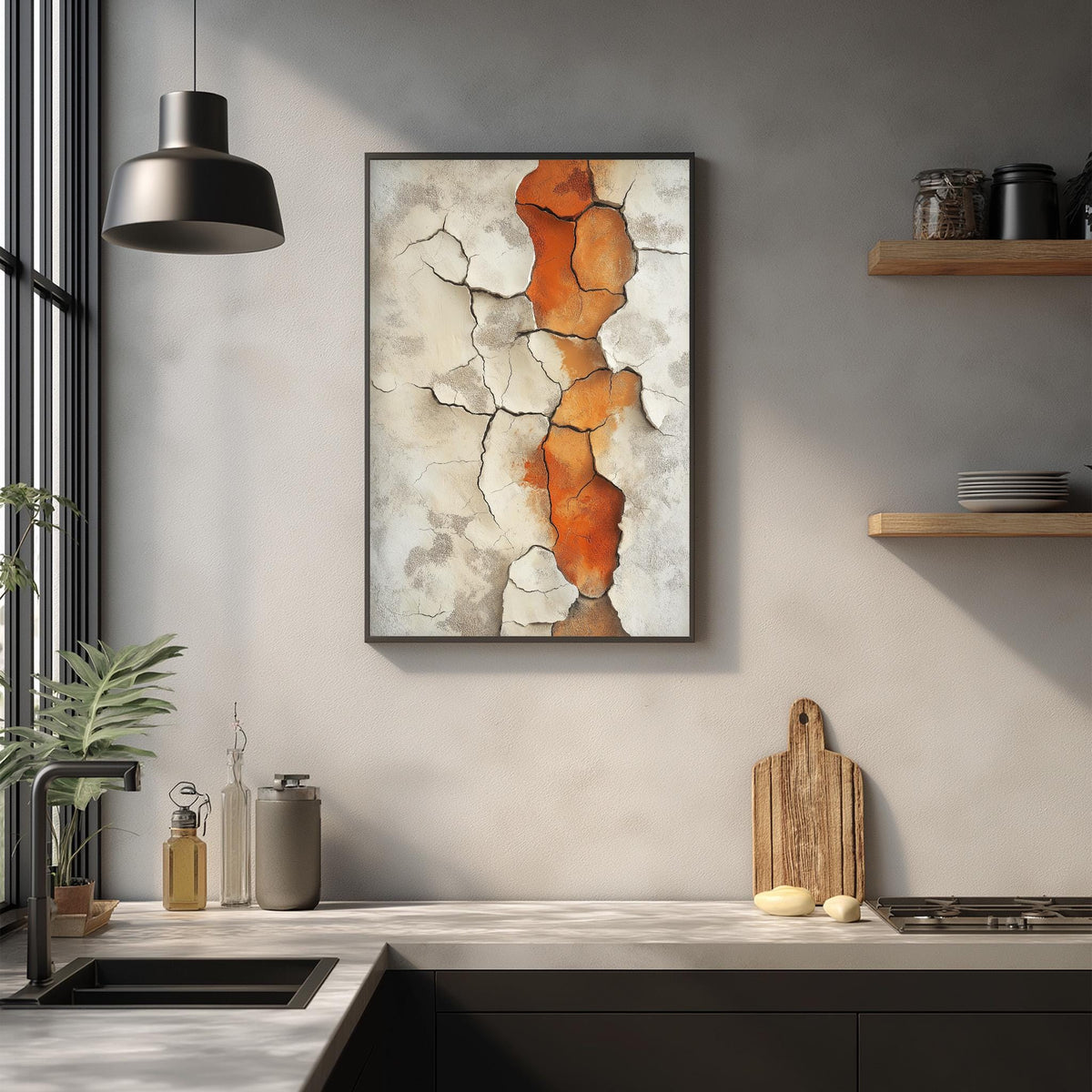 a kitchen counter with a framed artwork hanging above it, a wooden cutting board, and various kitchen items such as a bottle, a vase, and a bowl.