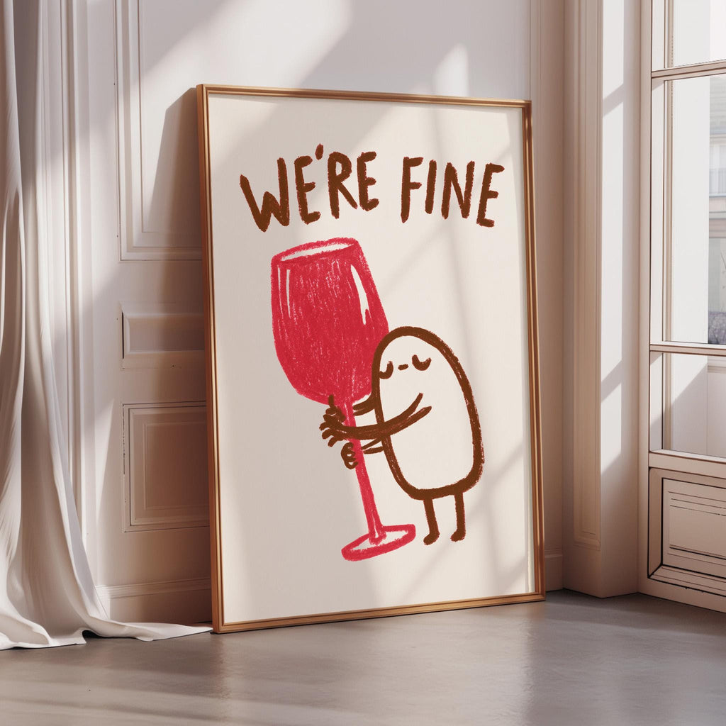 a framed poster with a cartoon character holding a large red wine glass, accompanied by the text "WE'RE FINE".