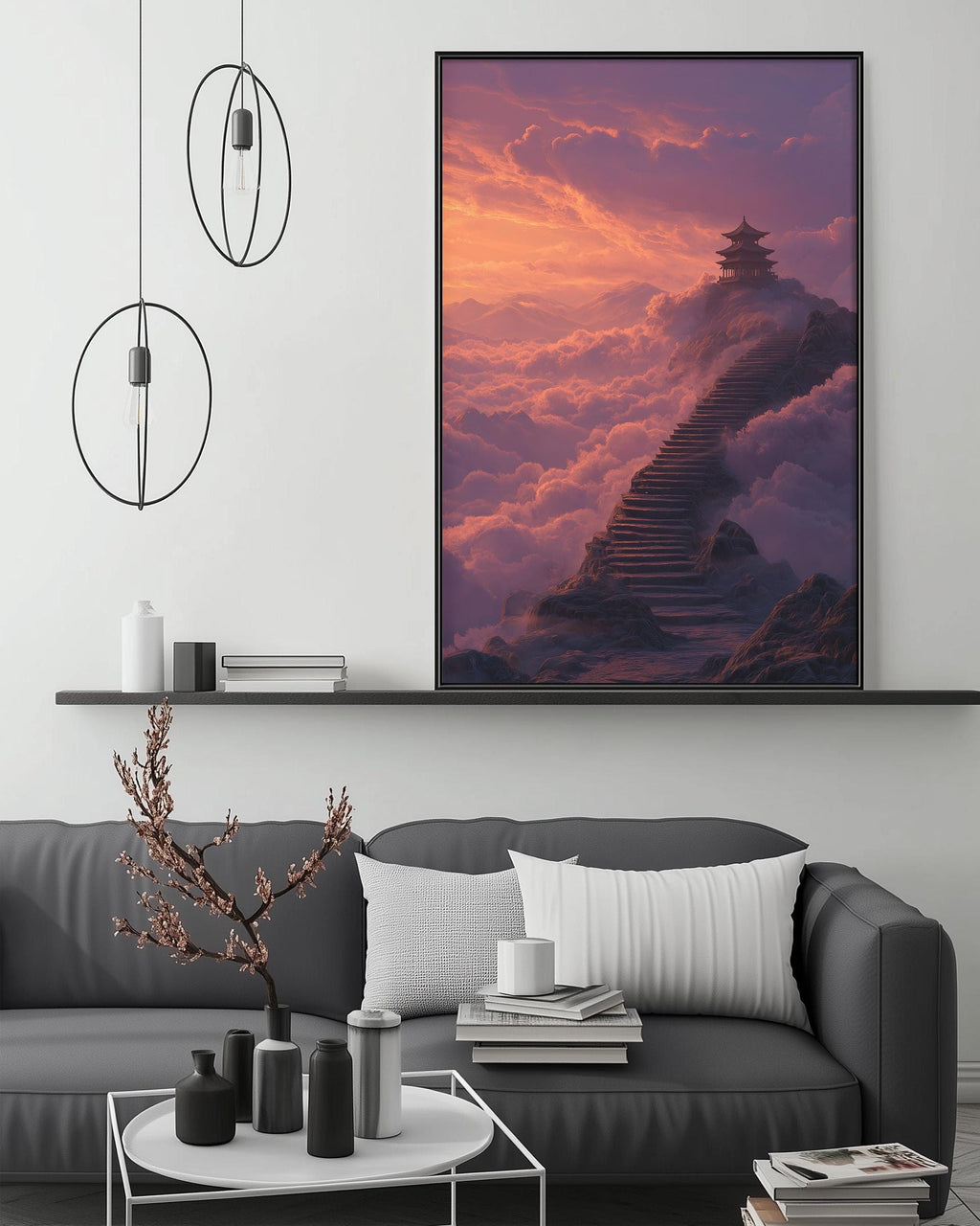 a large, square-shaped painting of a temple on a mountain, with a staircase leading up to it, set against a backdrop of a colorful sunset sky. The painting is hung on a wall above a gray couch, which has a coffee table in front of it. The room also includes a shelf with decorative items and a potted plant.