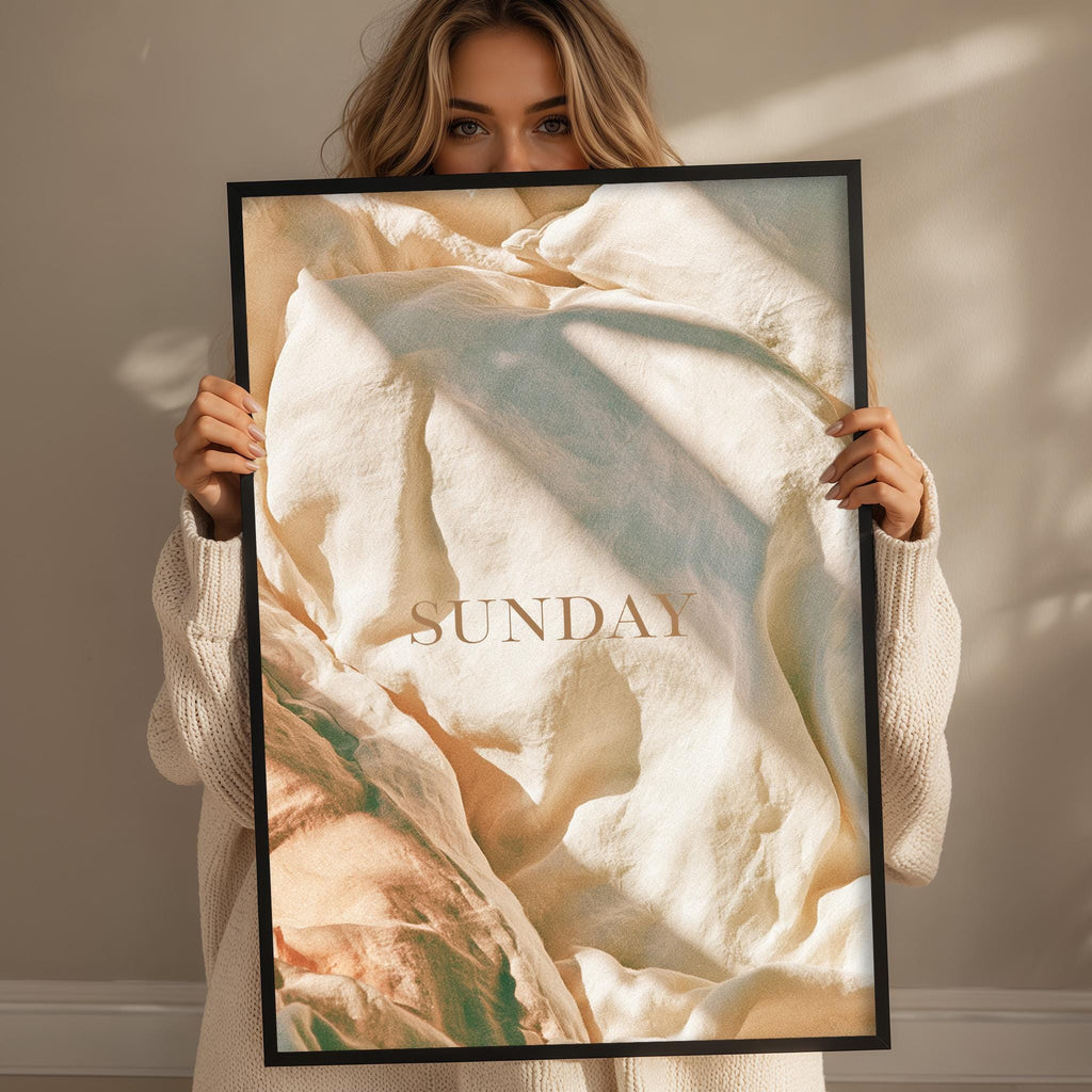 A woman holding a framed poster with the word "SUNDAY" written on it.
