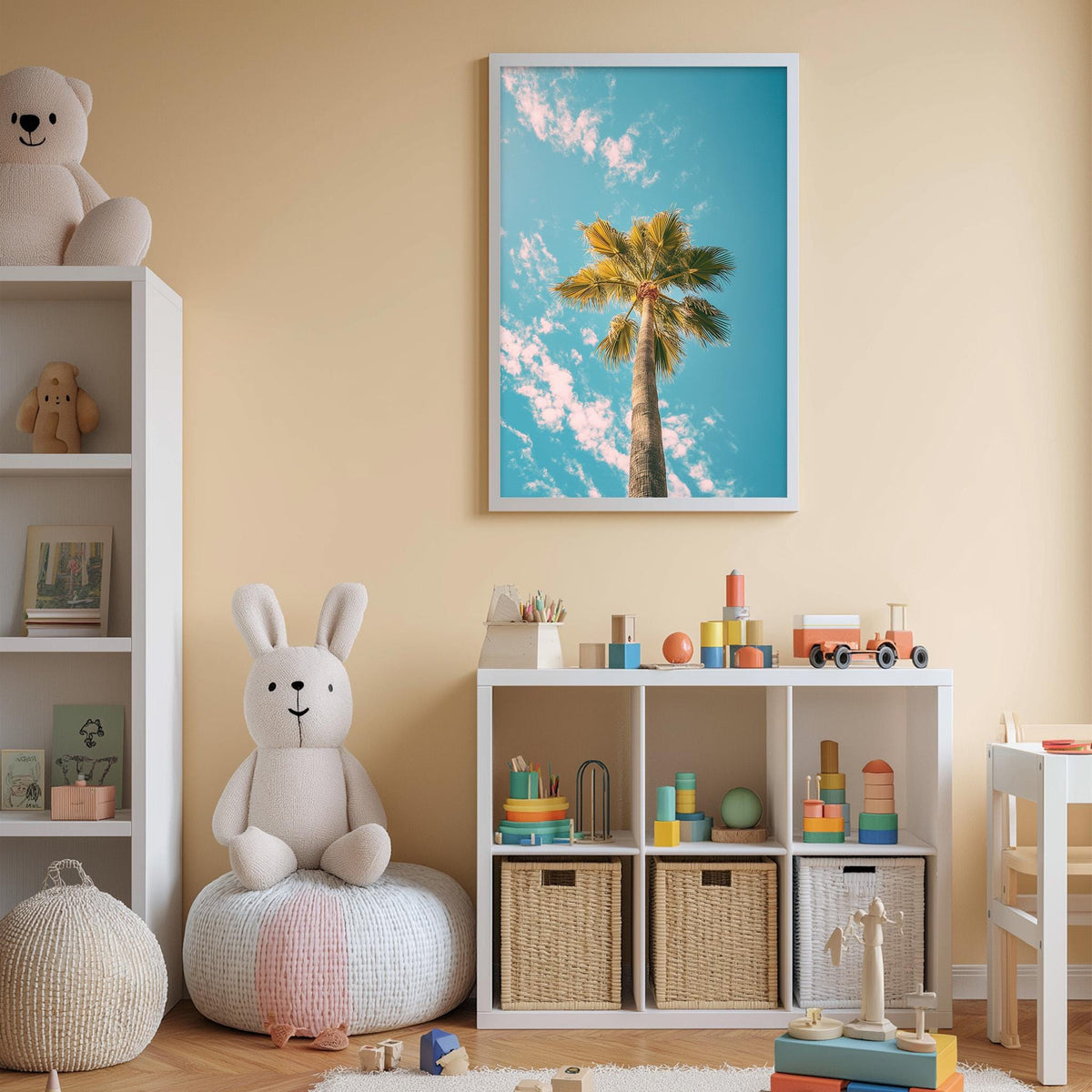 A child's bedroom with a white bookshelf, a stuffed rabbit, a toy train, and a framed picture of a palm tree on the wall.