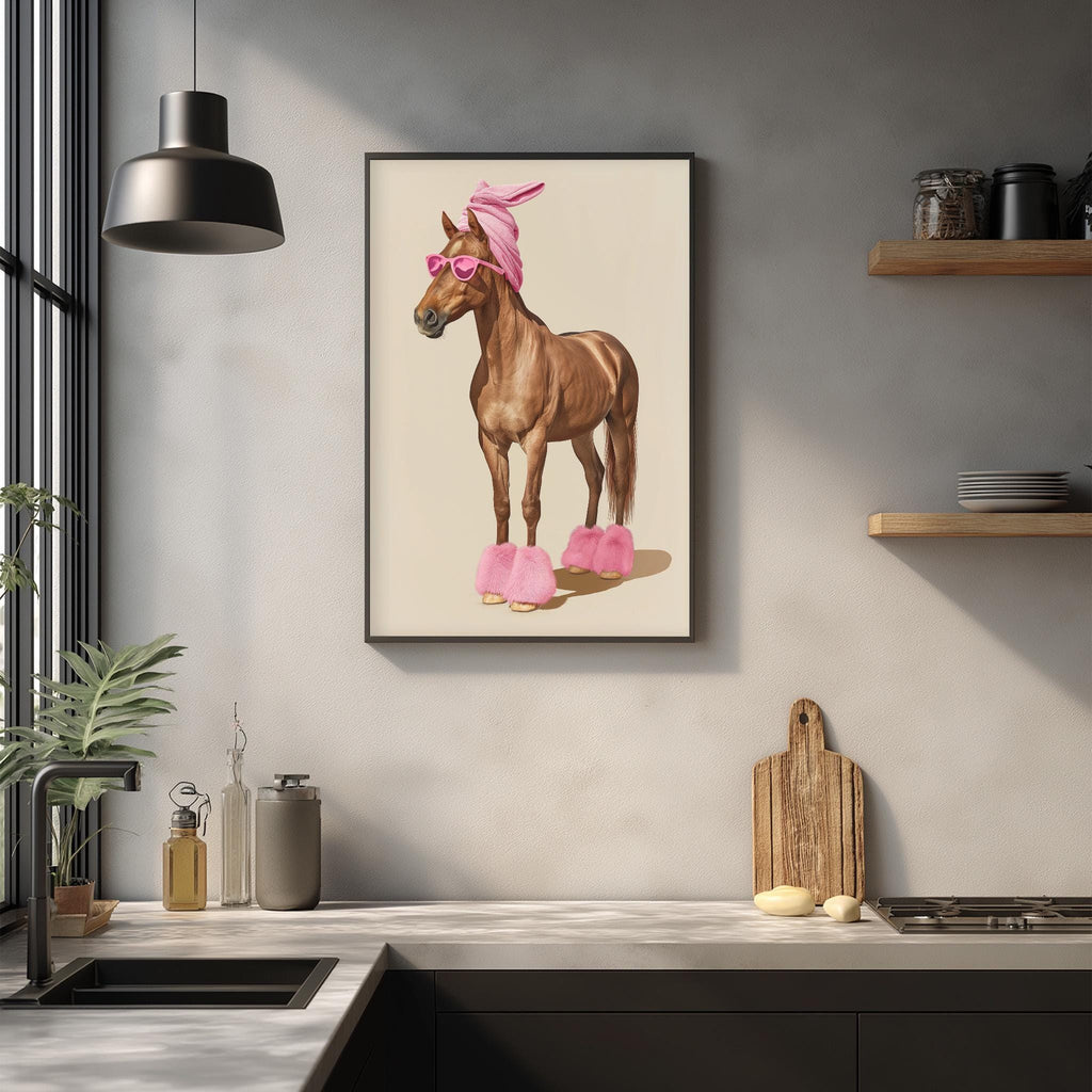 a kitchen counter with various items, including a framed picture of a horse wearing pink shoes, a wooden cutting board, and a potted plant.
