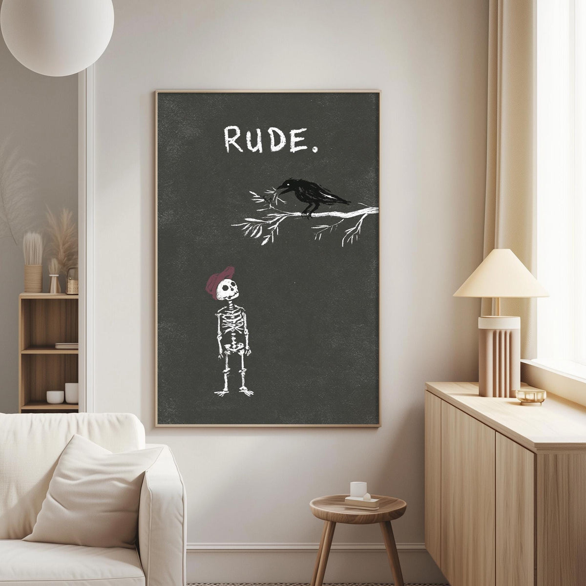 a living room with a white couch, a wooden side table, and a lamp. Above the couch, there is a framed poster with a skeleton wearing a red hat and a bird perched on a branch.