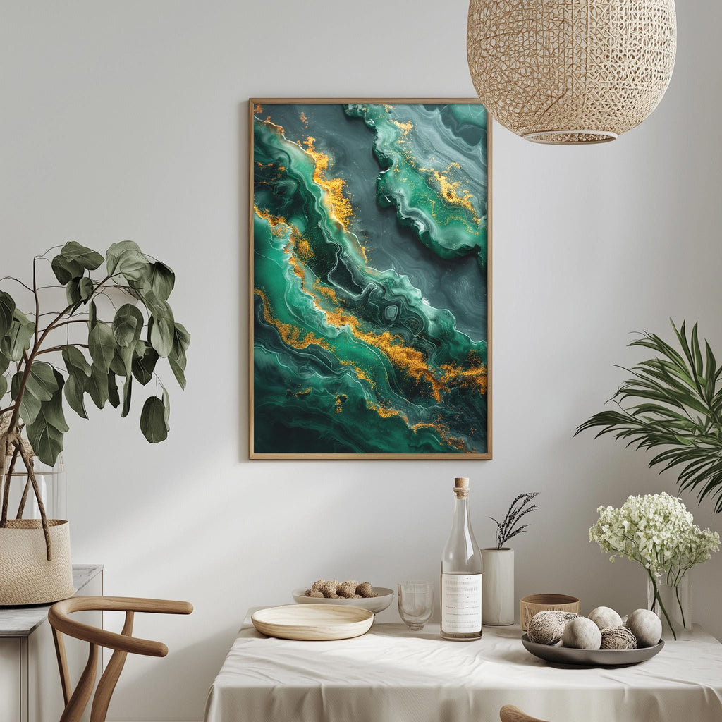a dining table with a white tablecloth, a bowl of fruit, a bottle, and a vase with flowers. Above the table, there is a framed painting of a green and yellow abstract design hanging on the wall.