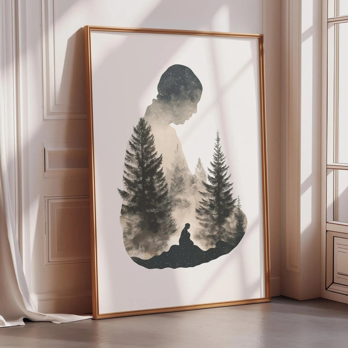 a framed artwork depicting a silhouette of a person standing in front of a forest of pine trees.