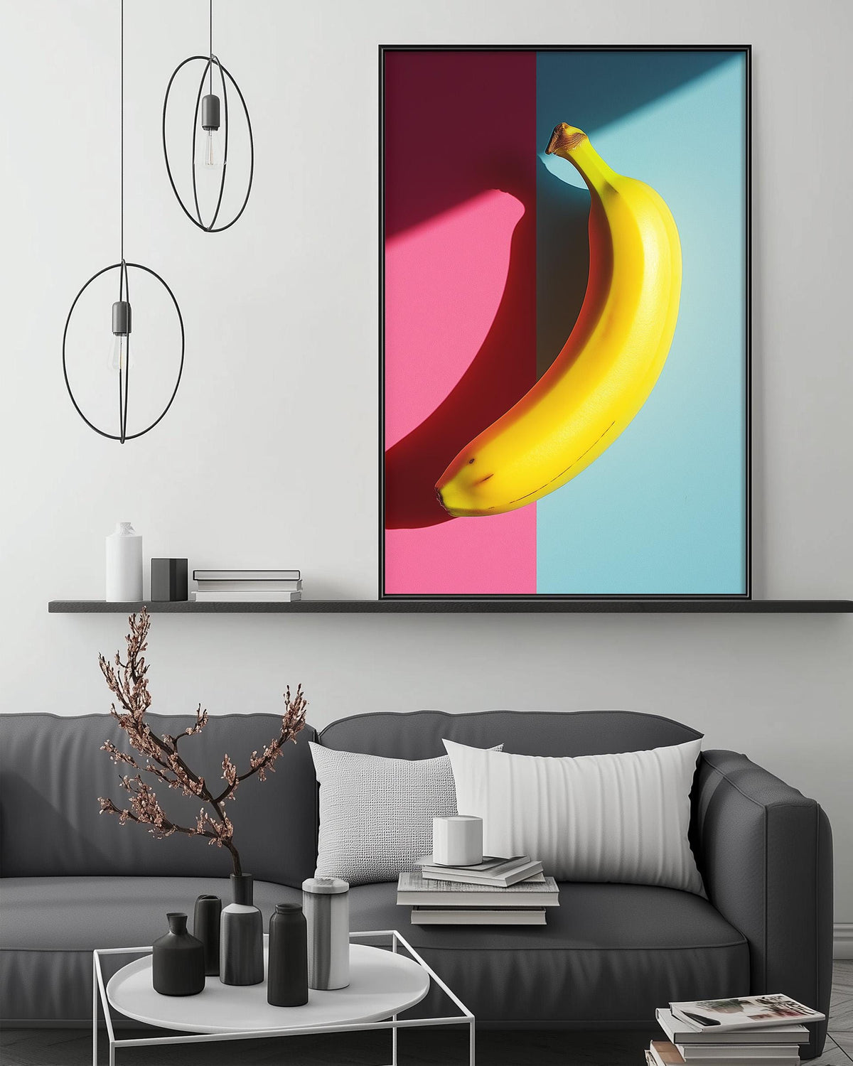 a modern living room with a gray sofa, a coffee table, and a large framed artwork of a banana on the wall.