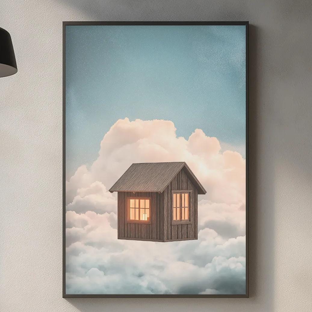 a kitchen counter with various kitchen items, including a cutting board, a soap dispenser, and a plant. Above the counter, there is a framed image of a small house floating in the sky, surrounded by clouds.