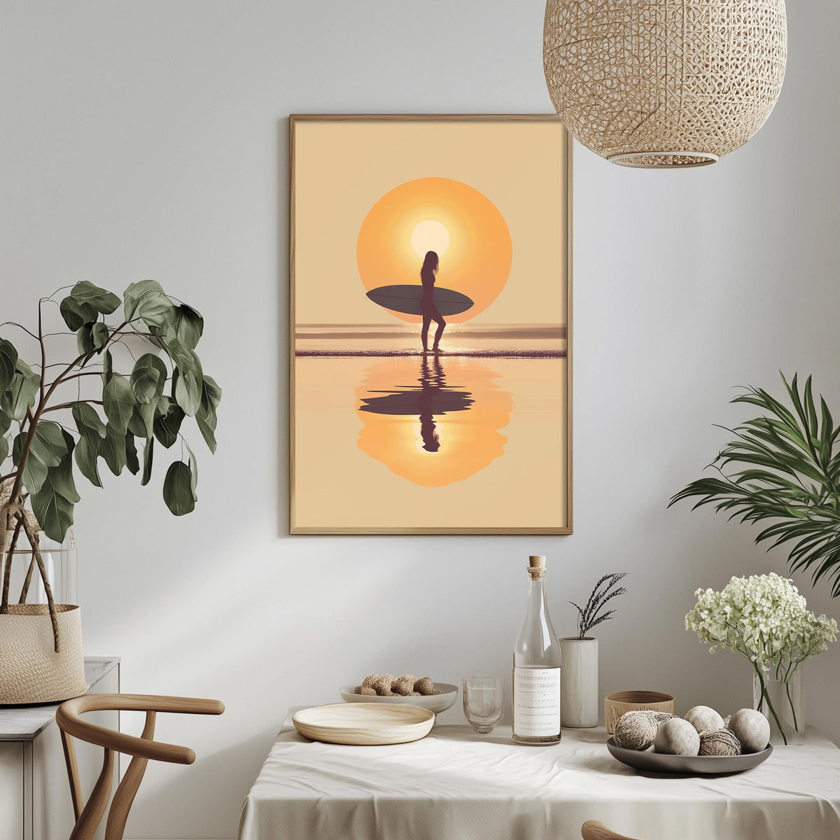 a framed picture of a surfer holding a surfboard, with a sunset reflection on the water in the background. The picture is hung on a wall above a dining table with various decorative items and plants.