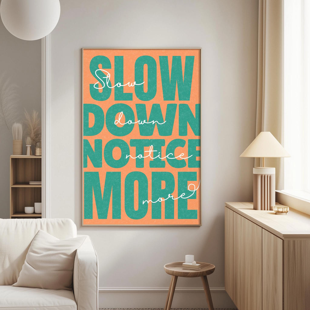 a poster with the text "Slow down, notice more" in a large, bold font.