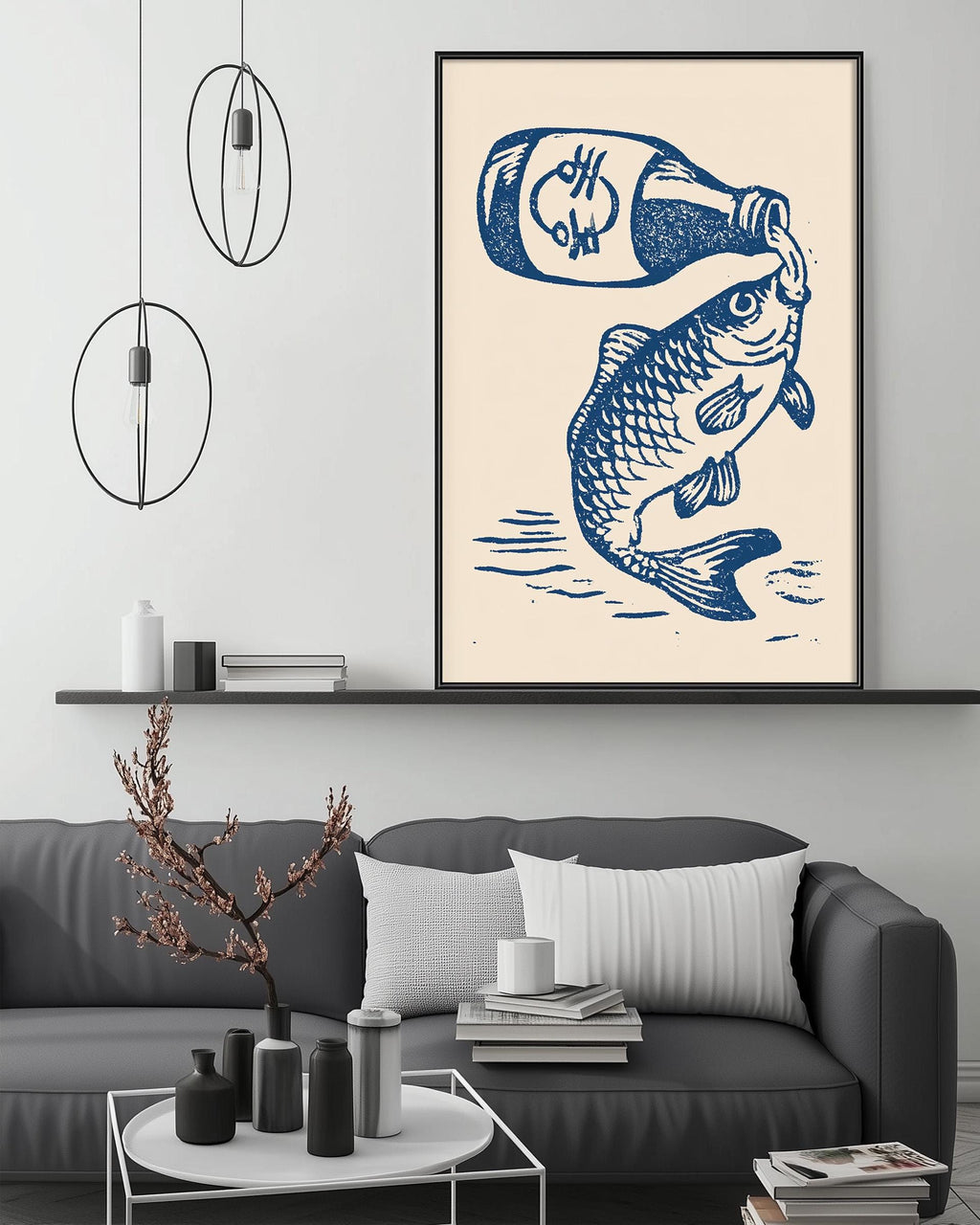 a large framed artwork depicting a fish with a bottle of beer, hanging on a wall above a gray couch with a coffee table in front of it.