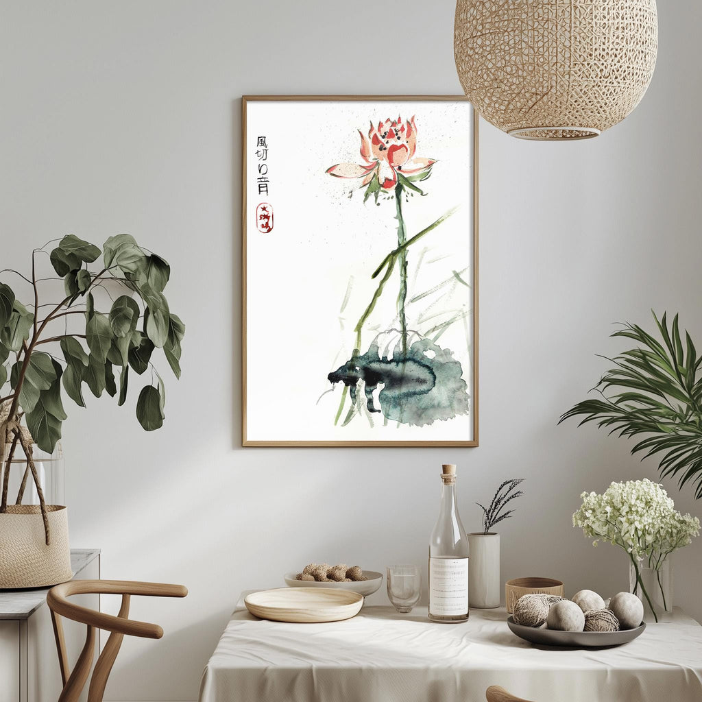 a dining table with a white tablecloth, a bowl of fruit, a bottle, and a vase with flowers. Above the table, there is a framed painting of a lotus flower with Chinese characters.