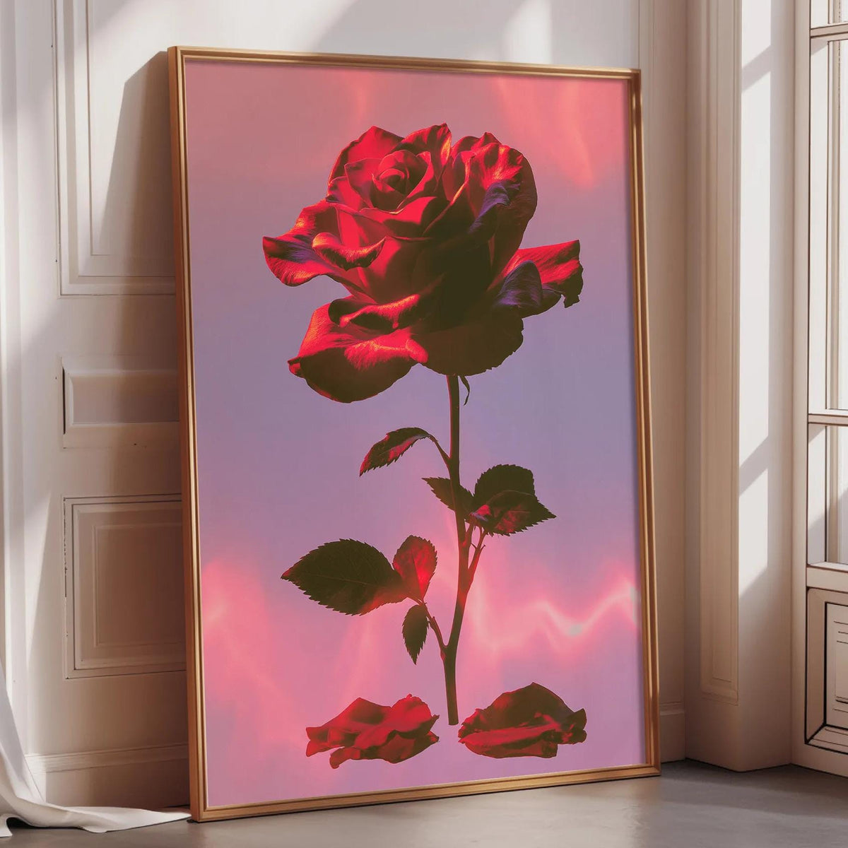A large framed poster of a vibrant red rose is displayed on a wall in a room with a window.